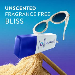 Sunglasses and sunscreen bottle on a straw with 'Unscented Fragrance Free Bliss' text against a blue gradient background